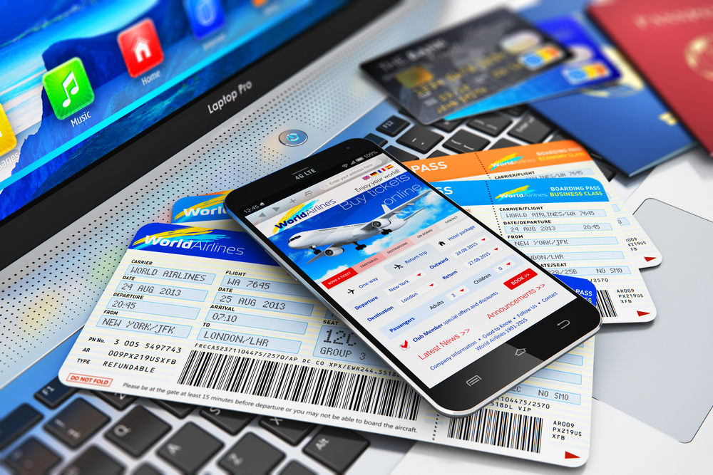 Airplane tickets and a phone that flashes flight details