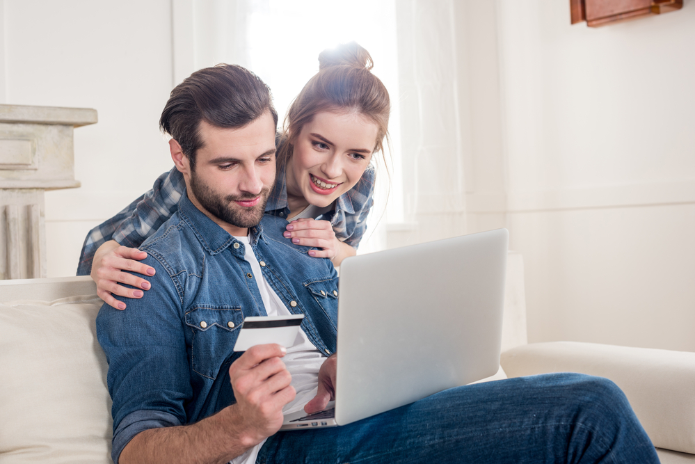 A couple with laptop and credit card