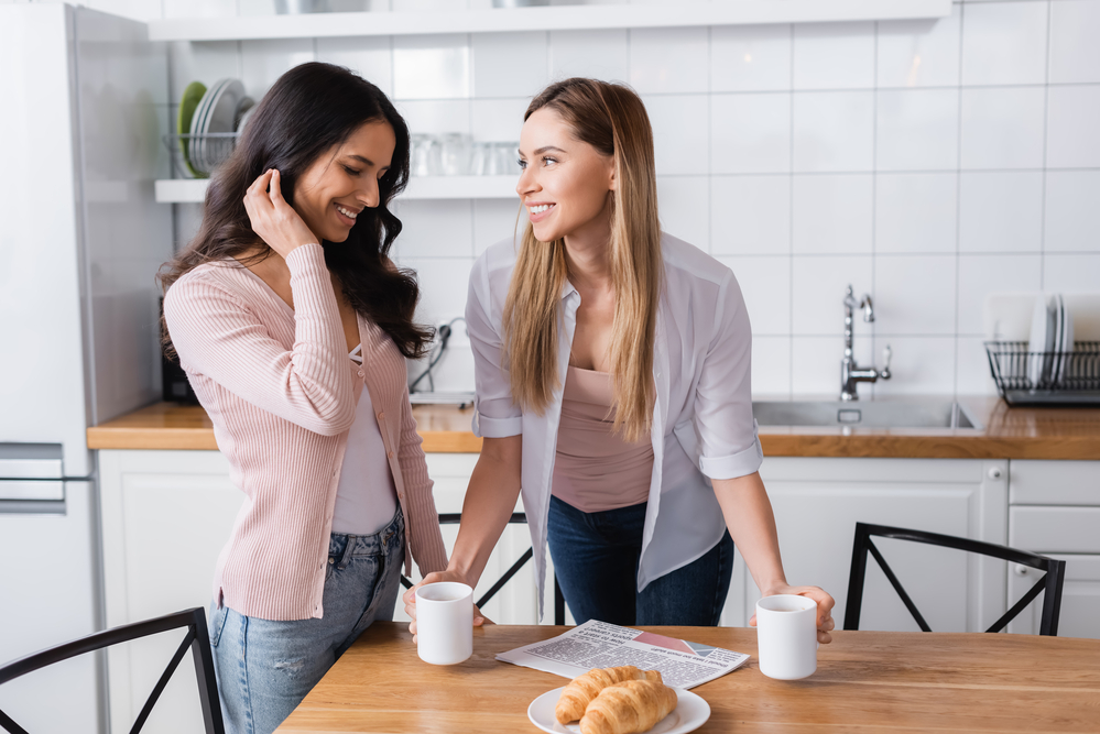 Two women in the kitchen about to have coffee and pastries
