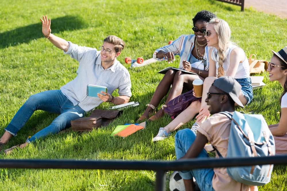 A group of young people on the campus lawn